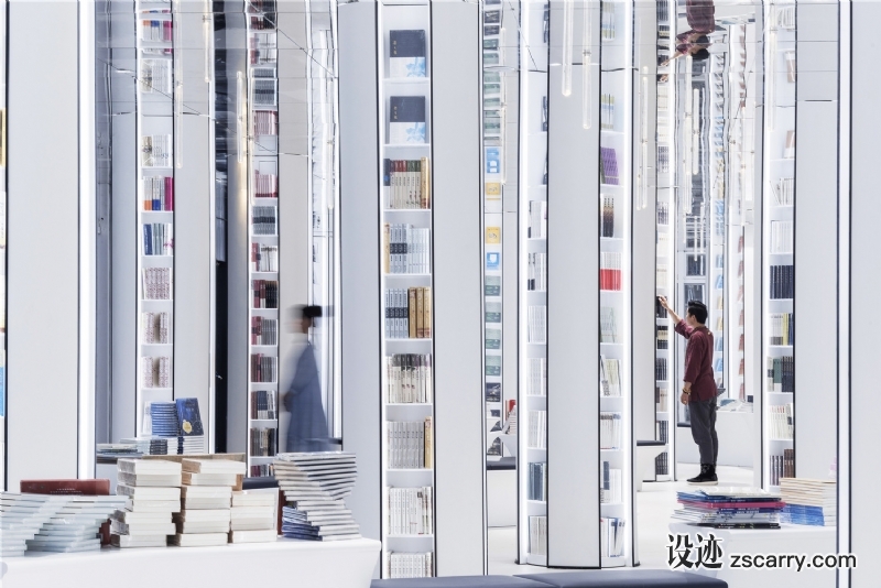 These_white_pillars_carrying_books_rise_up_straight_to_the_sky._Under_the_reflection_of_ceiling_mirror__they_seem_to_have_a_conversation_beyond_time..jpg 工装参考,商业空间,书店,