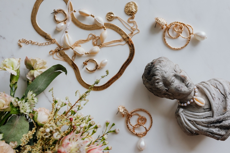 kaboompics_Gold jewellery in white marble - flowers and a small sculpture, a shell.jpg 方案配图,格调渲染,奢华,